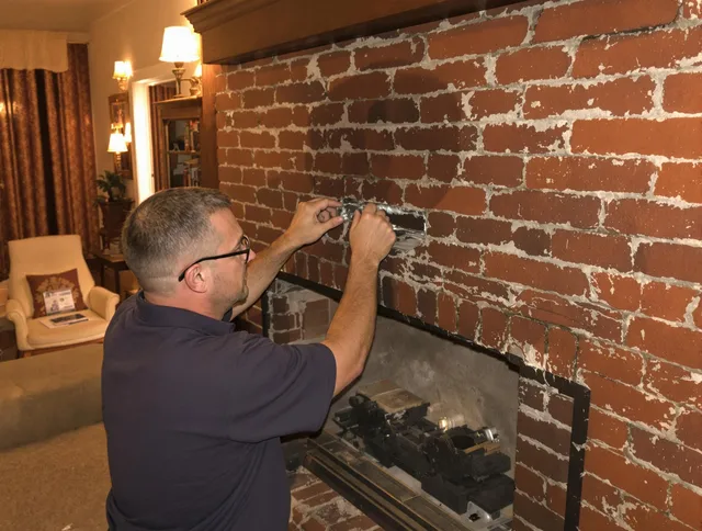 Greeley Chimney Sweep expert fixing a fireplace in Greeley, CO